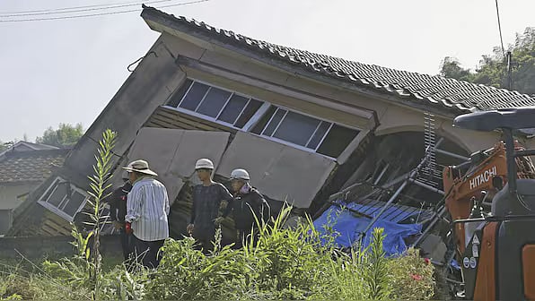 A collapsed house in Japan after yesterday's massive earthquake  - AP