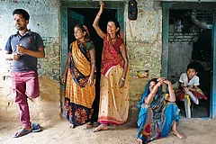 Photograph: Suresh K. Pandey : The Cycle of Misery:
Mithilesh Rajbanshi with his wife, mother and sister-in-law at their home in Bargaon village in Gaya, Bihar. The three worked as bonded labourers for years