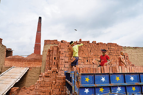 All for Daily Wages Brick kiln workers loading bricks in a truck near Patna