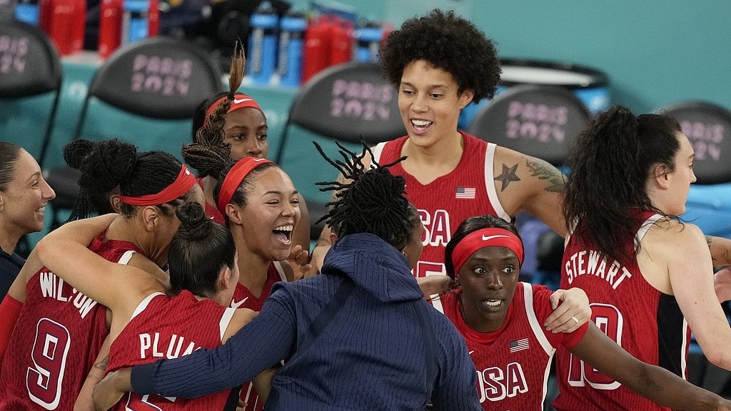 Photo: AP : The United States women's basketball team celebrates after winning the Paris Olympics gold medal match against France.