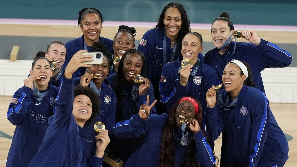 AP : The United States women's basketball team members pose for a picture with their Paris Olympics gold medals at Bercy Arena on Sunday (August 11). 