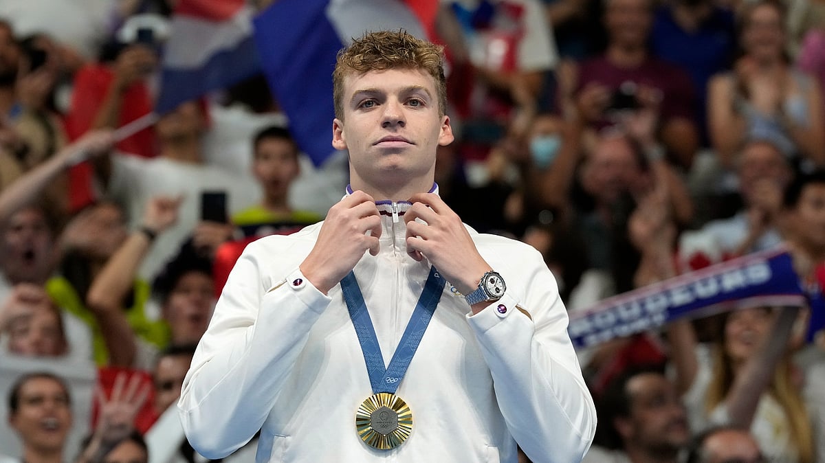 Leon Marchand of France reacts after receiving his gold medal
