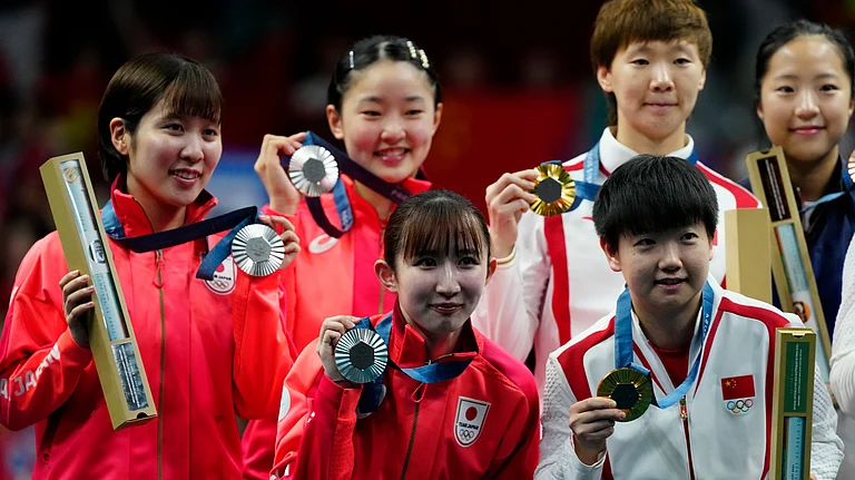 China gold medalists, right, and Japan silver medalists, left, pose during the medal ceremony of the women's team table tennis match at the 2024 Summer Olympics - AP