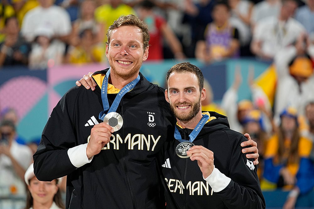 Paris Olympics Beach Volleyball medalists_Germanys Nils Ehlers and Clemens Wickler celebrate Silver