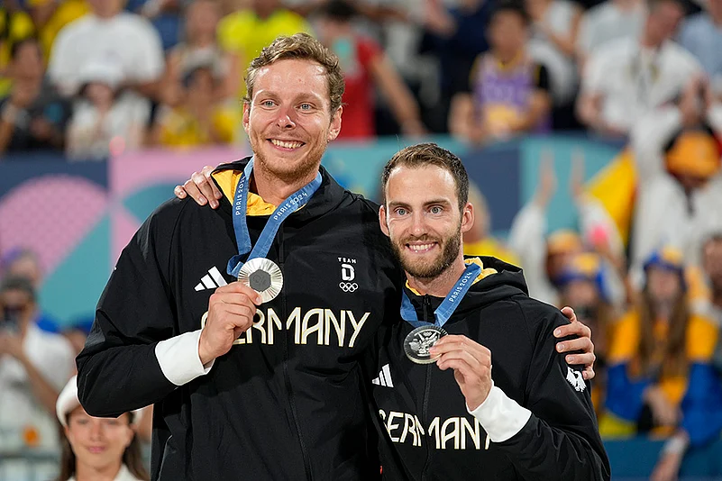 Paris Olympics Beach Volleyball medalists_Germanys Nils Ehlers and Clemens Wickler celebrate Silver