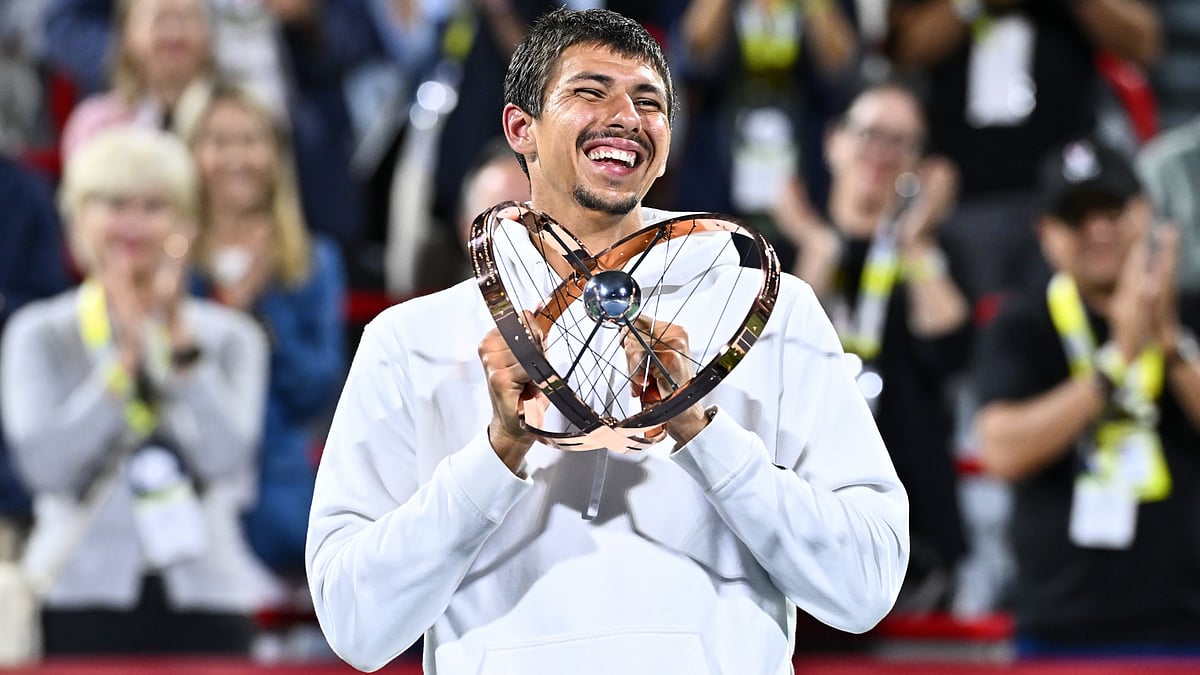 Alexei Popyrin celebrates his Canadian Open title with the trophy.