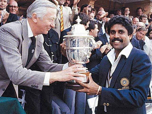 indian captain kapil dev holding trophy X