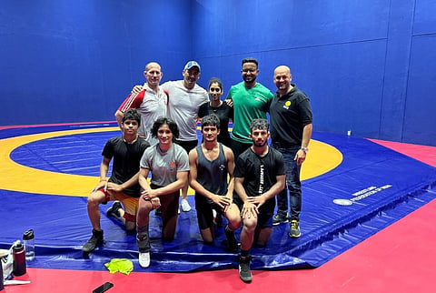 (Standing L-R) coach Woller Akos, Sports Scientist Dr Lombard, physio Ashwini, S&C Mayank, Viren Rasquinha. Sitting - Vinesh with her 3 sparring partners.