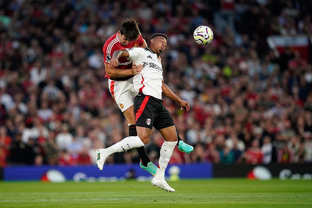 English Premier League 2024-25: Manchester United Vs Fulham_Harry Maguire challenges Rodrigo Muniz