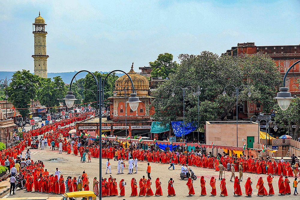 Women devotees carry holy water as they take part in Kalash Yatra during Shravan month, in Jaipur
