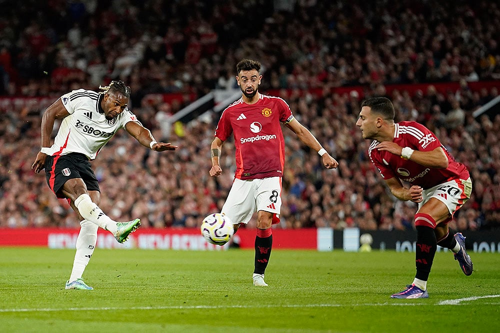 English Premier League 2024-25: Manchester United Vs Fulham_ Adama Traore, left, gets in a shot