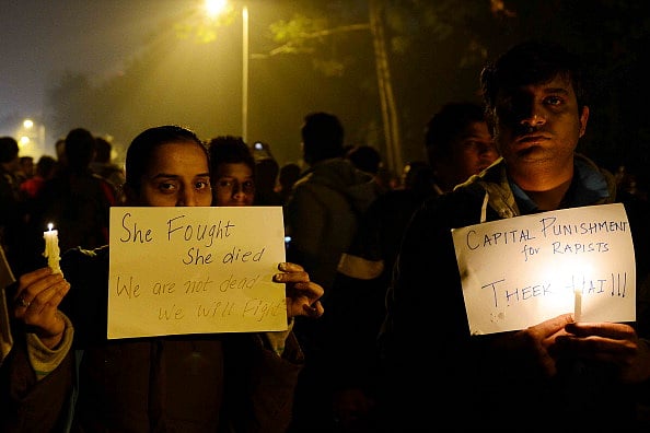 Protestors hold candles during a rally in New Delhi on December 29, 2012, after the death of victim.
