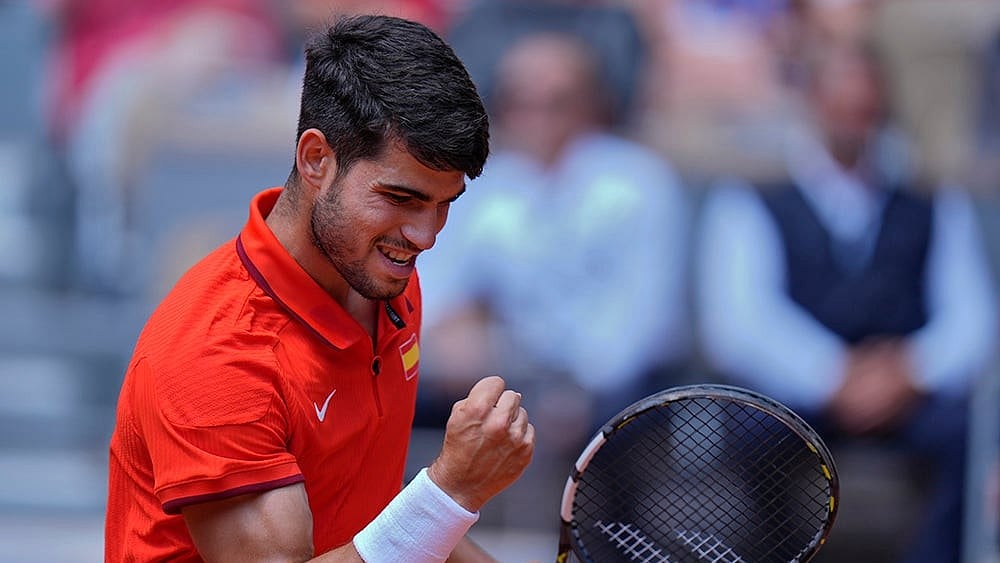 | Photo: AP/Andy Wong : Carlos Alcaraz reacts after scoring a point against Felix Auger-Aliassime 