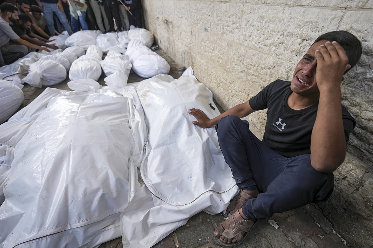 A Palestinian weeps at the funeral of his relatives in Gaza |