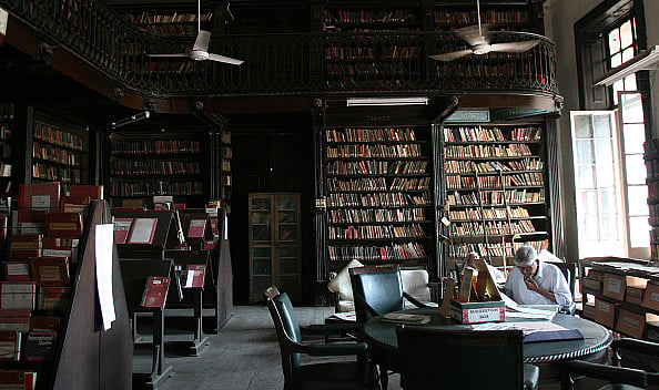 Getty Images : Lost in the sea of books - A man surfs through the books in National Library Bandra