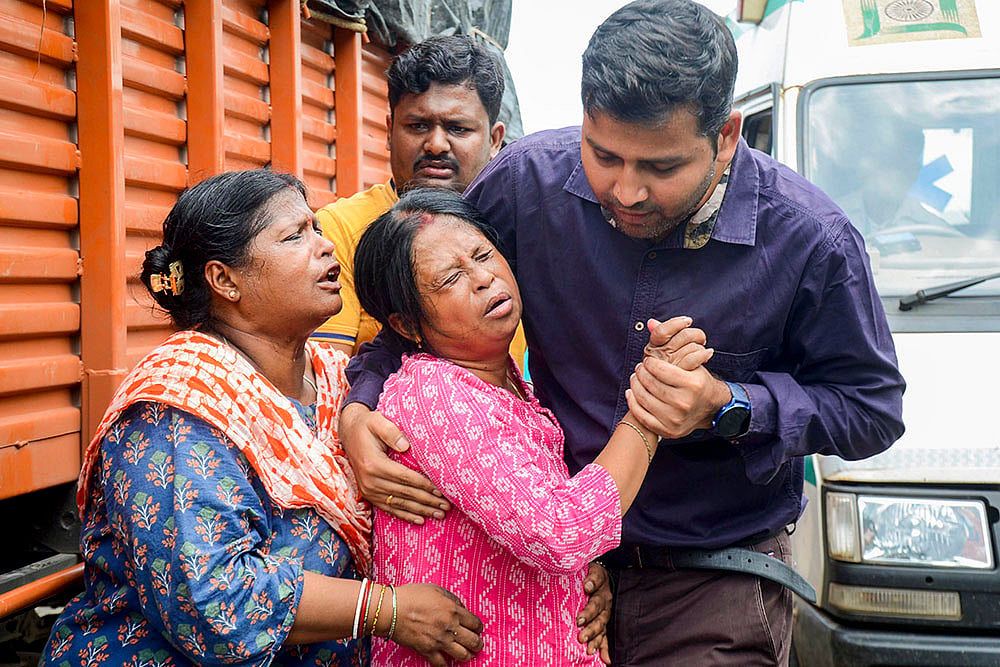Relatives of Subhrodeep Dutta, trainee pilot of missing aircraft react after his body was recovered