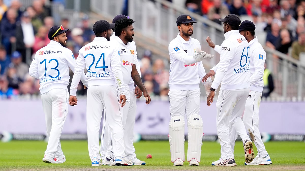 Nick Potts/PA via AP : Sri Lanka's Dinesh Chandimal, centre, celebrates catching out England's Joe Root on day two of the First Test match between England and Sri Lanka at Emirates Old Trafford, Manchester.