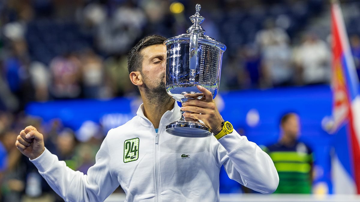 Novak Djokovic celebrates with the trophy in 2024