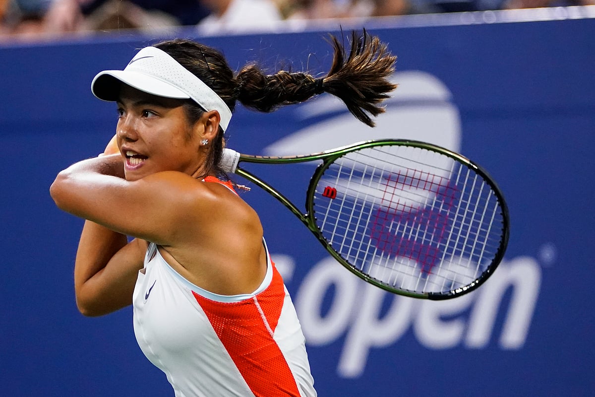 (AP Photo/Frank Franklin II, File) : FILE - Emma Raducanu, of Britain, returns a shot to Alize Cornet, of France, during the first round of the US Open tennis championships, Aug. 30, 2022, in New York. 