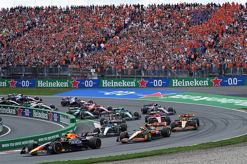 Red Bull driver Max Verstappen of the Netherlands, left, leads the field after the start the Formula One Dutch Grand Prix race at the Zandvoort racetrack, Netherlands, Sunday, Aug. 25, 2024.