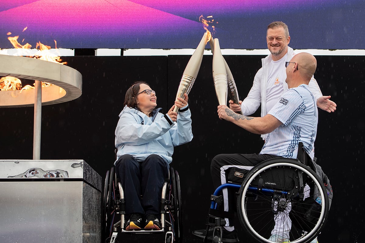  (AP Photo/Thomas Krych) : British Paralympians Helene Raynsford and Gregor Ewan light the Paralympic Flame in Stoke Mandeville, widely considered the birthplace of the Paralympic Games, England, Saturday, Aug. 24, 2024.