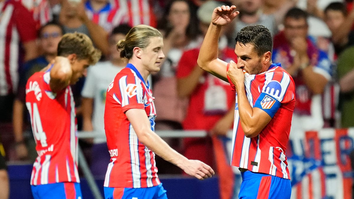 Koke (right) celebrates Atletico's third goal.