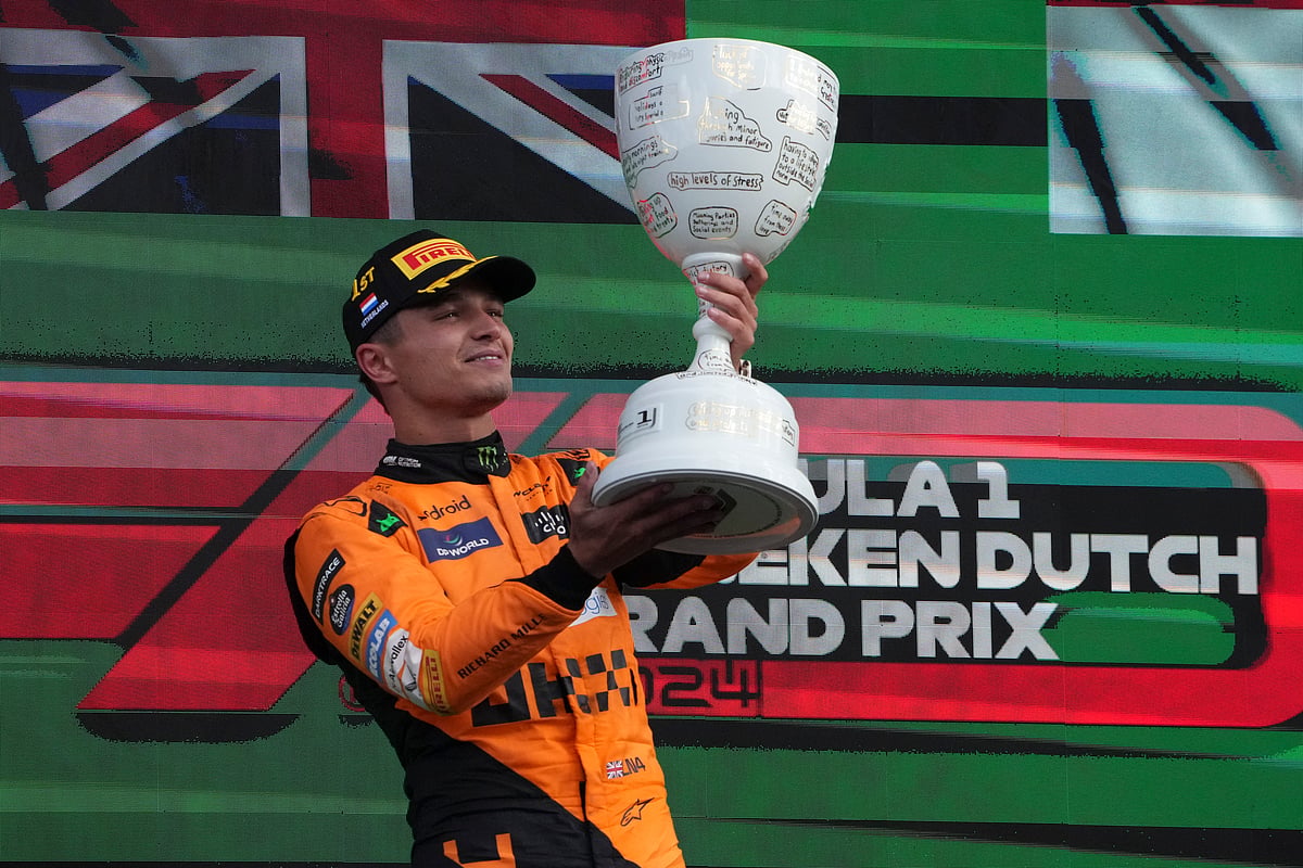 (AP Photo/Peter Dejong) : McLaren driver Lando Norris of Britain celebrates after winning the Formula One Dutch Grand Prix race at the Zandvoort racetrack, Netherlands, Sunday, Aug. 25, 2024. 