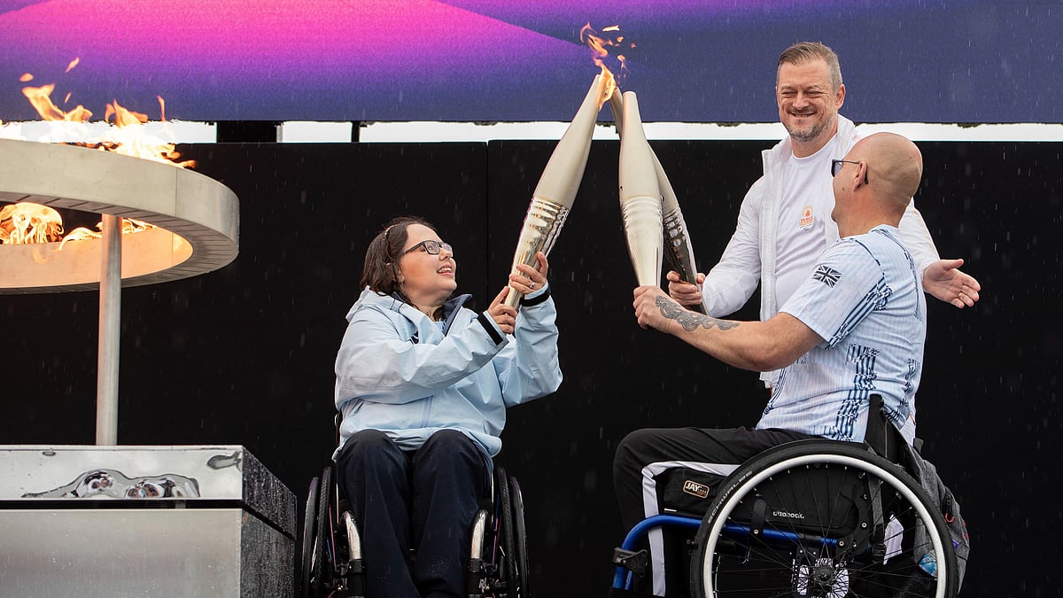 British Paralympians Helene Raynsford (left) and Gregor Ewan light the Paralympic Flame in Stoke Mandeville, England on Saturday ( August 24, 2024). - AP/Thomas Krych