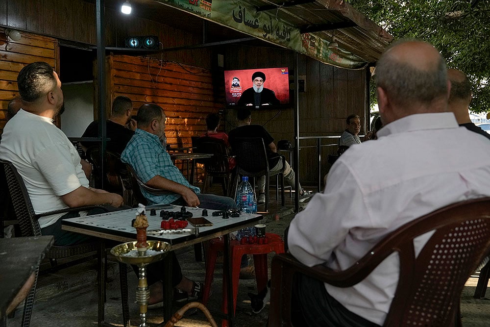 Middle East Tensions_People listen to a speech by Hezbollah leader Sayyed Hassan Nasrallah in Beirut