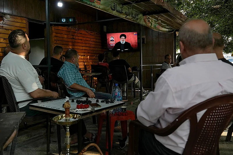 Middle East Tensions_People listen to a speech by Hezbollah leader Sayyed Hassan Nasrallah in Beirut
