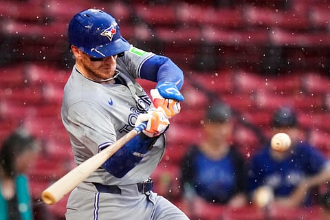 Toronto Blue Jays' Danny Jansen takes swings on a pitch shortly before the game was delayed during his at-bat due to heavy rain in the first inning of a baseball game at Fenway Park, Wednesday, June 26, 2024, in Boston. Jansen, who was traded by the Blue Jays to the Red Sox on July 27th, is scheduled to be in the line-up against his former team when the delayed game continues on Aug. 26, 2026. Jansen would become the first major league player to appear in the same game for both teams. 