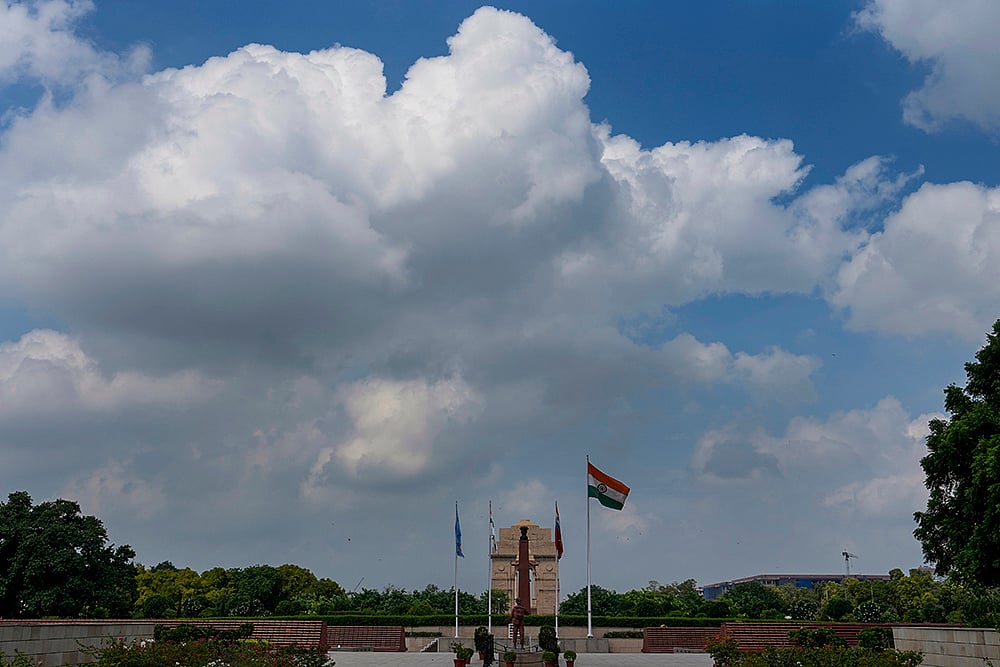 Clouds hover in the sky over the India Gate, in New Delhi
