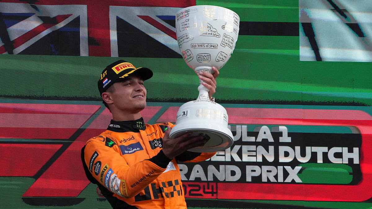 (AP Photo/Peter Dejong) : McLaren driver Lando Norris of Britain celebrates after winning the Formula One Dutch Grand Prix race at the Zandvoort racetrack, Netherlands, Sunday, Aug. 25, 2024. 