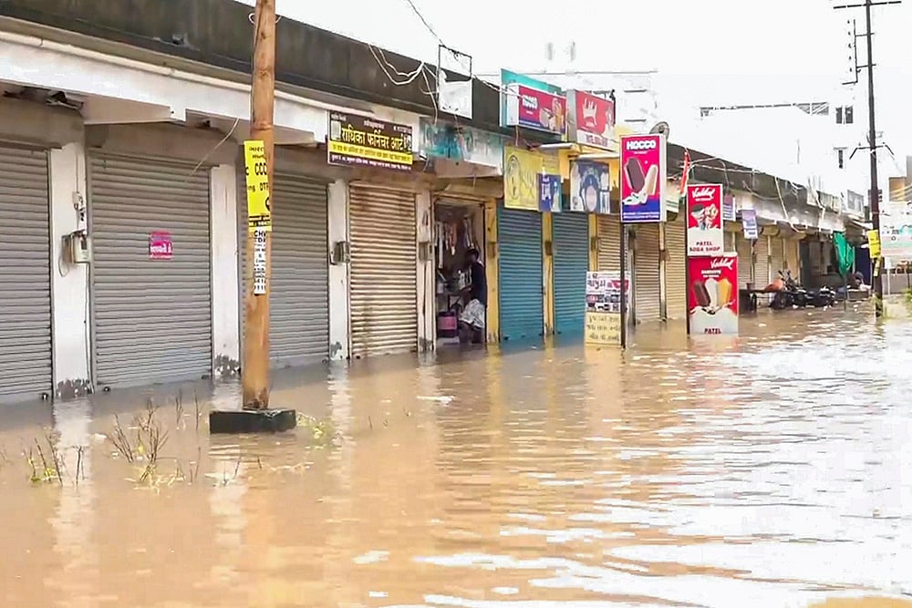A partially submerged market area following rainfall, in Vadodara