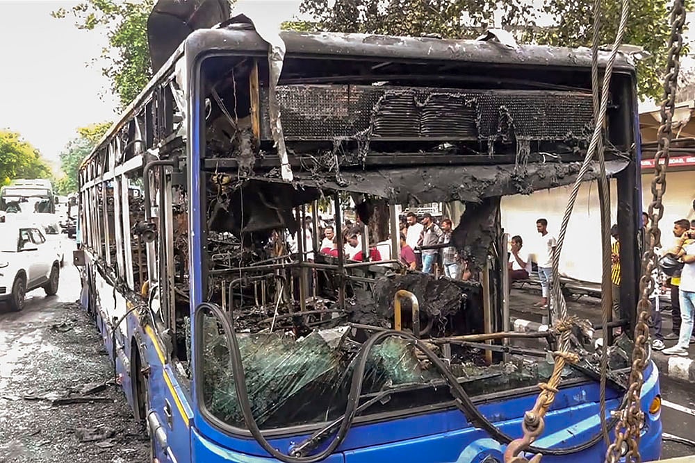 Charred remains of a low-floor DTC bus in east Delhis Jagatpuri