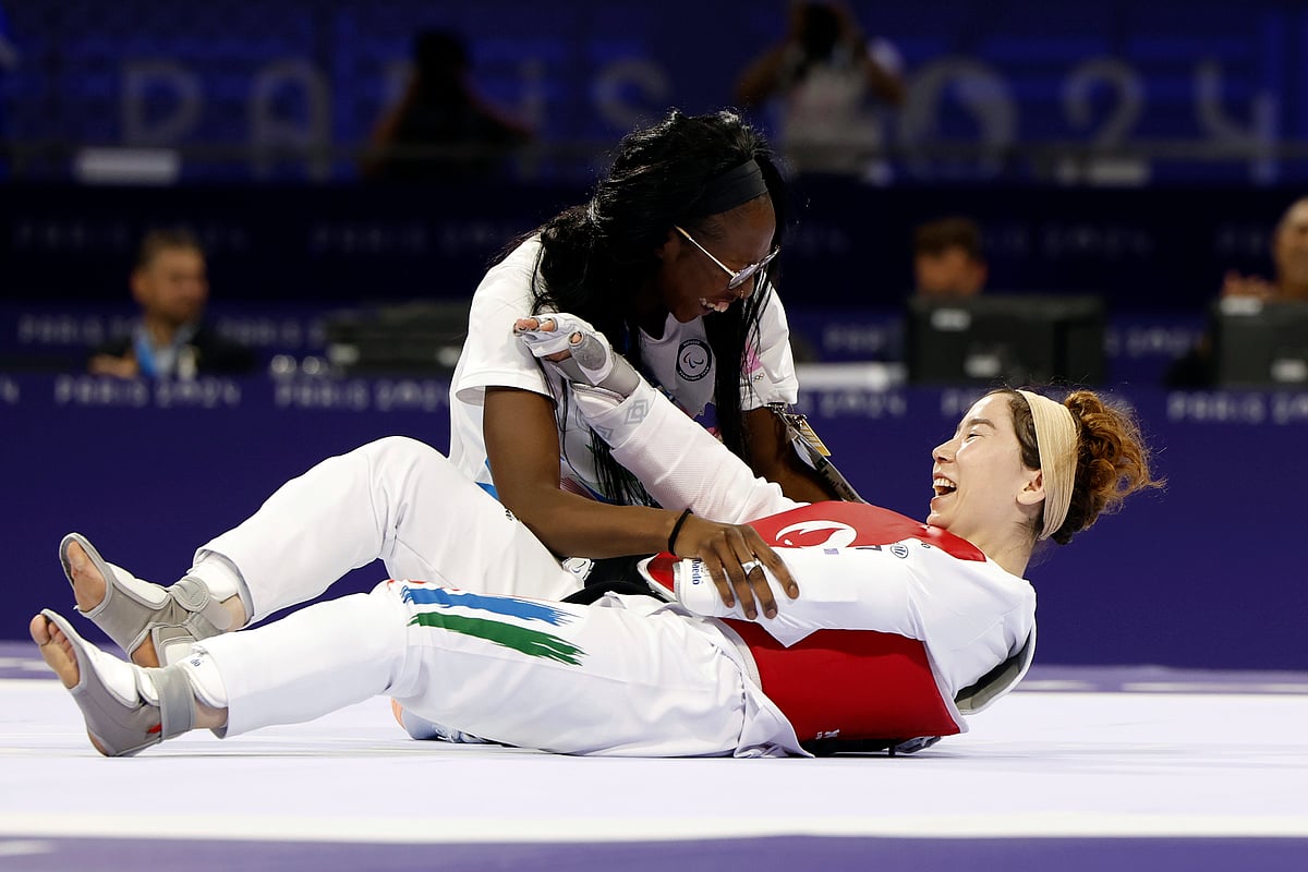 Zakia Khudadadi from the Paralympic Refugee Team, bottom, celebrates her bronze medal in Para Taekwondo during the Paralympic Games in Paris, Thursday, Aug. 29, 2024. 

 - (AP Photo/Madeleine Mertens)

