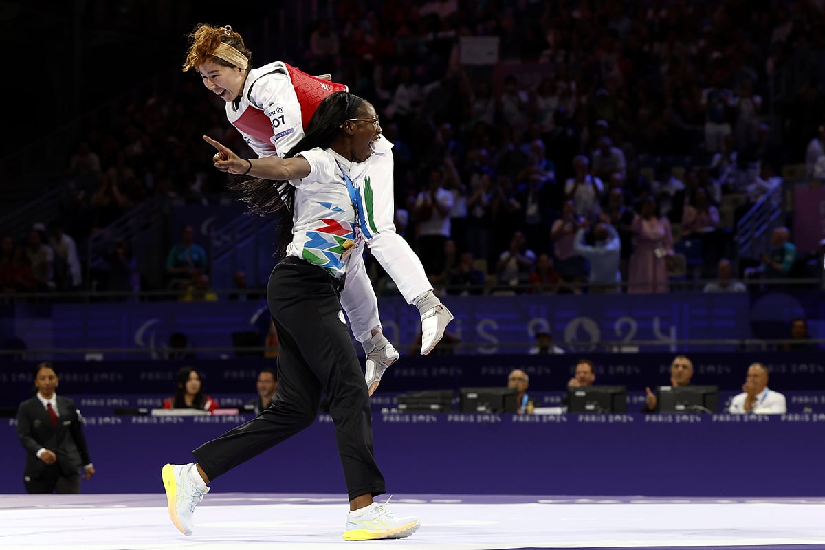 Zakia Khudadadi from the Paralympic Refugee Team, top, celebrates her bronze medal in Para Taekwondo during the Paralympic Games in Paris, Thursday, Aug. 29, 2024.  - (AP Photo/Madeleine Mertens)