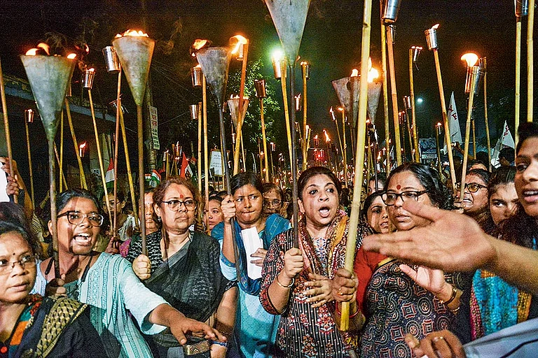 Holding A Vigil: People take part in a torch rally in Kolkata on August 14, 2024 - Photo: PTI