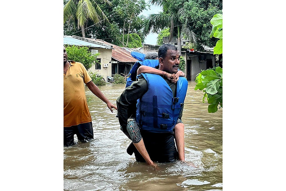 Gujarat Monsoon Rain and Floods_A stranded person being rescued at flood-hit Vadodara