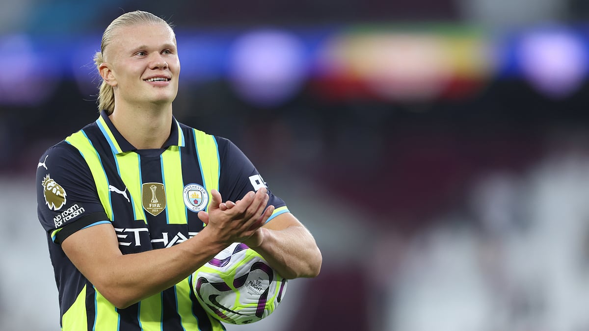 Erling Haaland applauds Manchester City's fans after collecting the match ball on Saturday.
