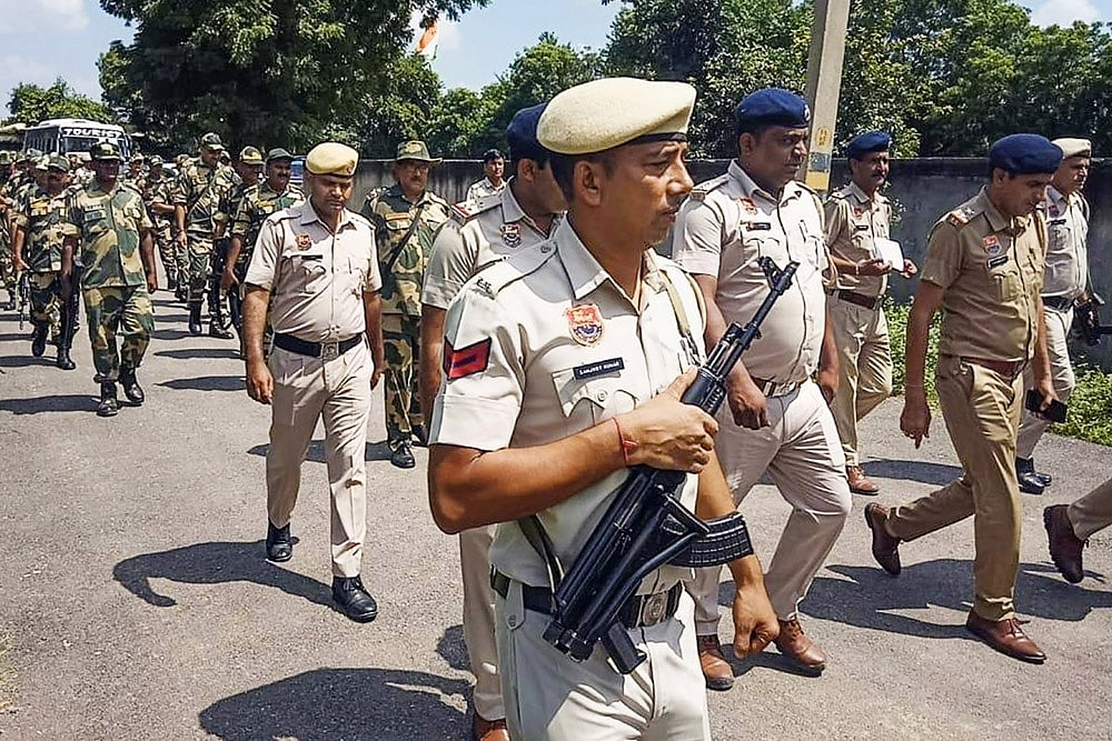 BSF and police personnel conduct a flag march ahead of Haryana polls