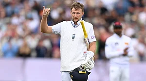 Root celebrates his record-breaking century.