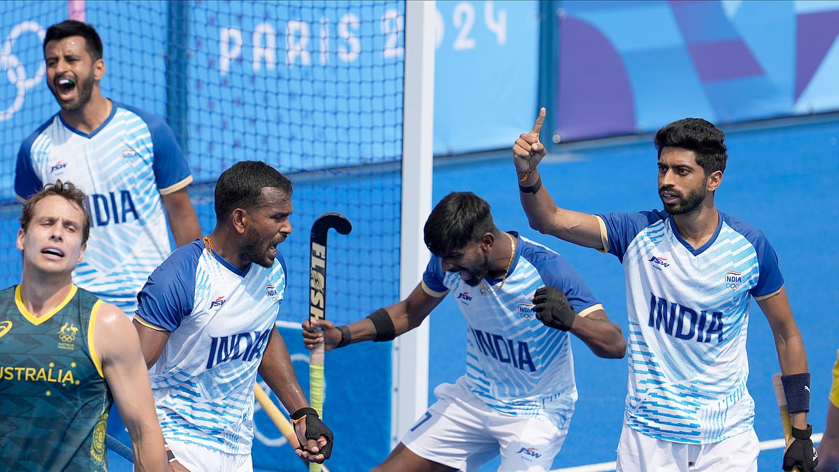 AP Photo/Anjum Naveed : India's Shamsher Singh, left, and teammates jubilate on the end of the men's field hockey match between Australia and India at the Yves-du-Manoir Stadium, at the 2024 Summer Olympics.