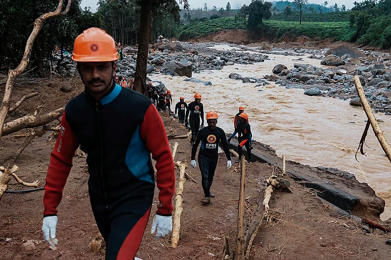 Rescuers make their way to the upper regions as they search through mud and debris for a third day after landslides in Wayanad - AP