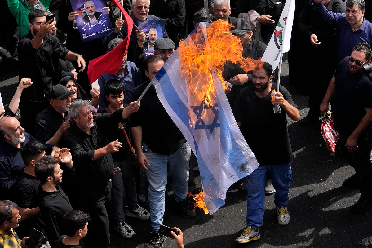 AP : Iranians burn a representation of the Israeli flag during the funeral ceremony of Hamas leader Ismail Haniyeh