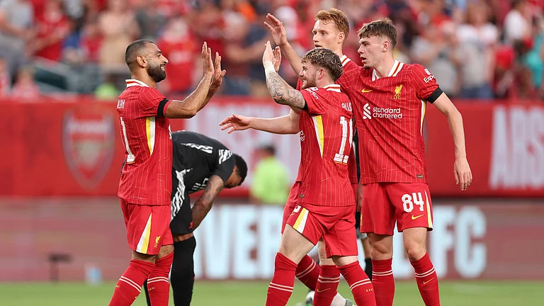Liverpool's Mohamed Salah and Harvey Elliott celebrate. - null