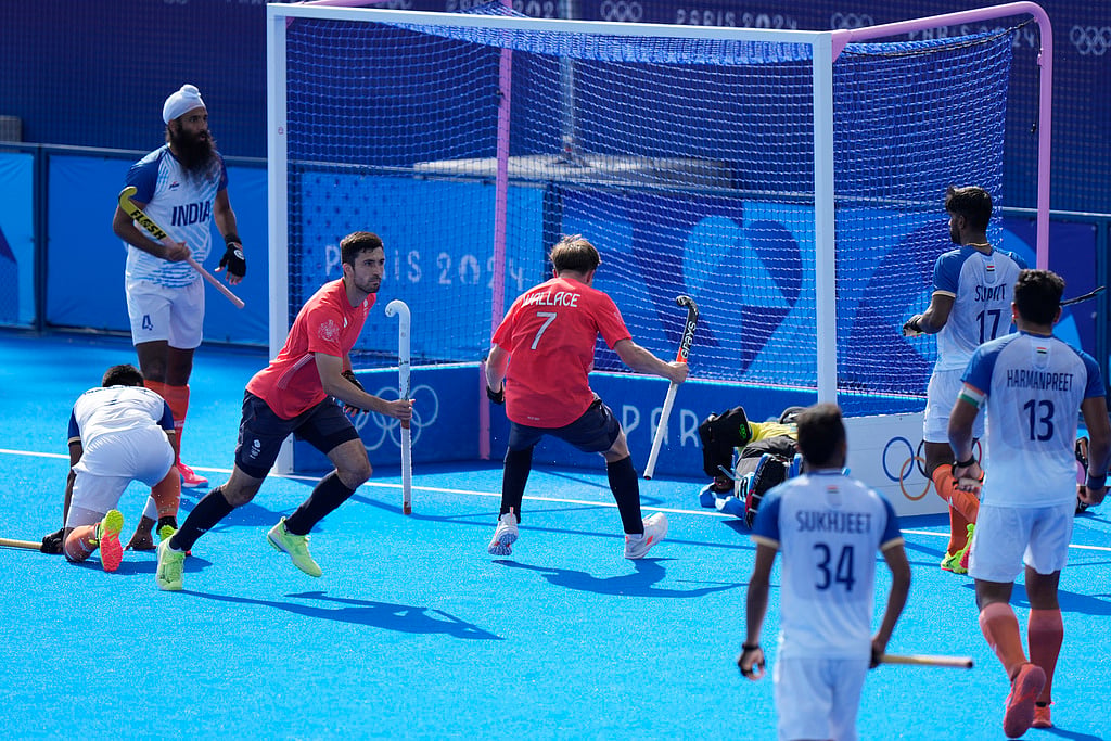 Britain's Lee Morton, third left, celebrates after scoring his side's first goal during the men's quarterfinal field hockey match between Britain and India at the Yves-du-Manoir Stadium during the 2024 Summer Olympics, Sunday, Aug. 4, 2024, in Colombes, France. - AP/Aijaz Rahi