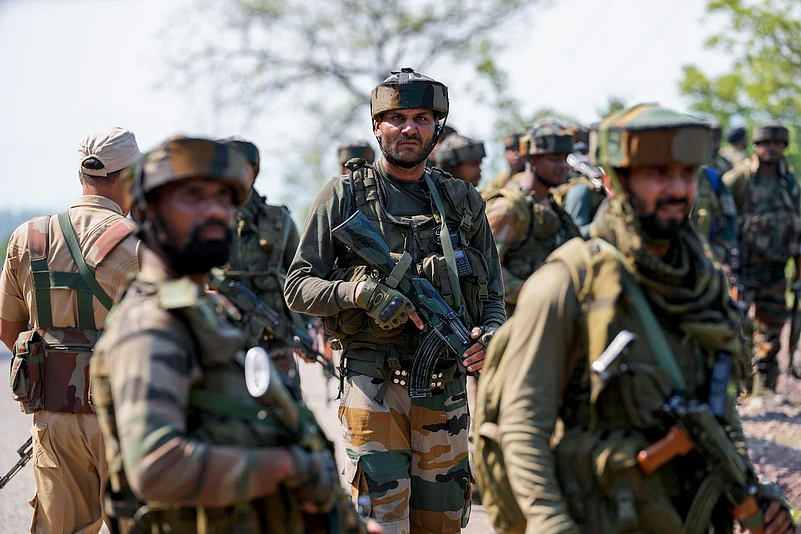 Indian army soldiers patrol the area where a bus fell into a deep gorge in Reasi district