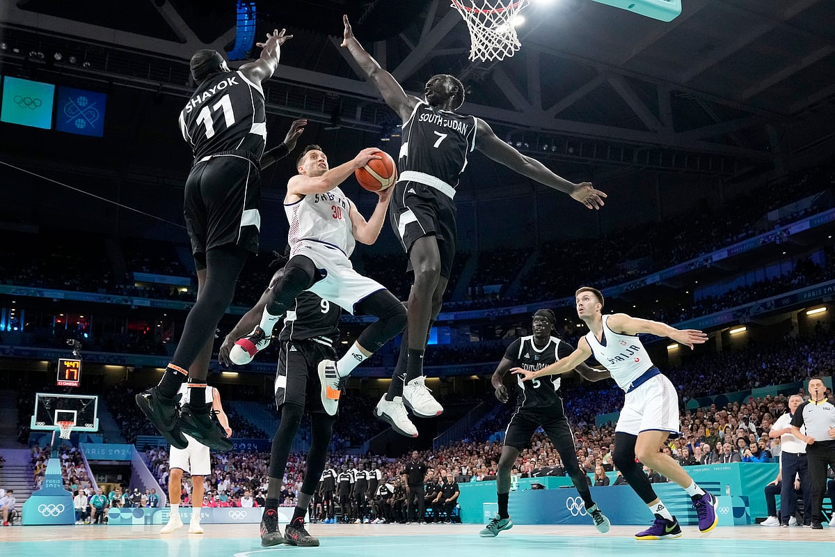 Serbia's Aleksa Avramovic (30) shoots as South Sudan's Marial Shayok (11), South Sudan's Wenyen Gabriel (9) and South Sudan's Bul Kuol (7) defend during a men's basketball game at the 2024 Summer Olympics, Saturday, Aug. 3, 2024, in Villeneuve-d'Ascq, France.

 -  (AP Photo/Michael Conroy)
