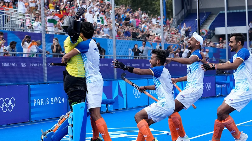 Parattu Reveendran Sreejesh, left, celebrates with teammates. AP Photo